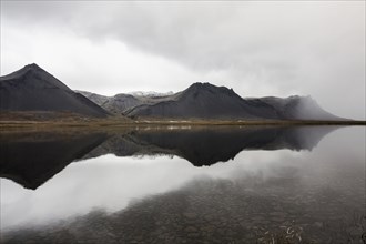Mountains reflecting in still lake