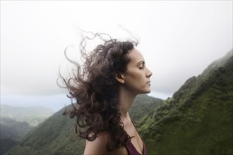 Wind blowing hair of Mixed Race woman