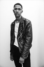 Portrait of serious Black man wearing leather jacket
