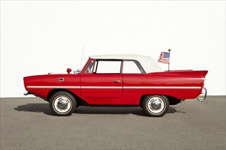 Red vintage convertible car with American flag