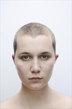 Portrait of serious Caucasian woman with shaved-head
