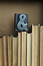 Ampersand sign on top of books