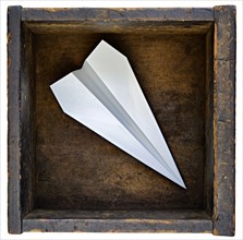 Paper airplane in wooden box