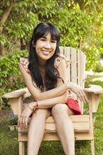 Woman sitting in chair outdoors
