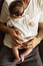 High angle view of father holding baby boy