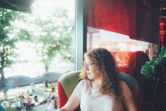 Woman relaxing in chair near window