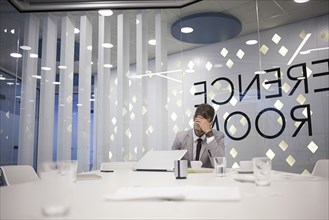 Caucasian businessman working in conference room