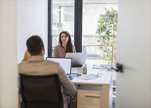 Caucasian business people working at desks in office