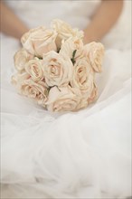 Close up of bride holding bouquet of flowers