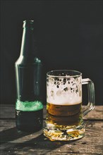 Glass and bottle of beer on table