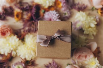 Close up of wrapped gift and flowers