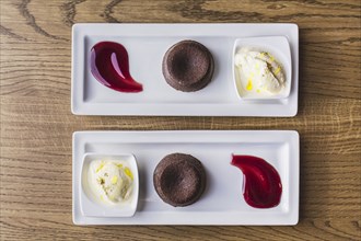 Platters of chocolate souffle dessert with ice cream and sauce