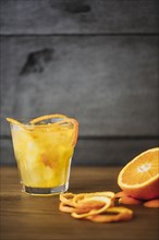 Orange juice with peel and sliced fruit