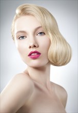 Caucasian woman with glamorous hairstyle and makeup