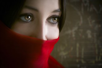 Close up of woman wearing red face scarf
