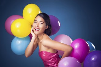 Woman smiling with party balloons