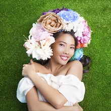 Woman wearing flower crown on artificial grass