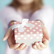 Close up of girl holding wrapped gift