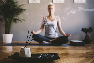 Caucasian woman meditating in yoga studio