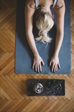 Caucasian woman practicing yoga in studio