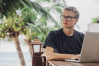 Caucasian man using laptop outdoors