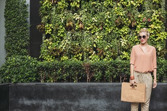 Caucasian woman carrying purse outdoors