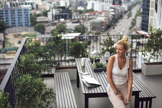 Caucasian woman standing on balcony