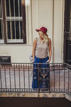 Caucasian woman standing on balcony