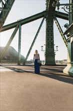 Caucasian woman standing on bridge