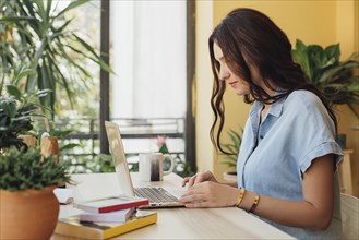 Caucasian woman using laptop at desk