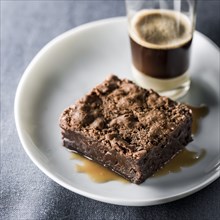 Brownie on plate with espresso