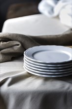 Stack of plates on tablecloth