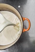 Milk pouring into pot