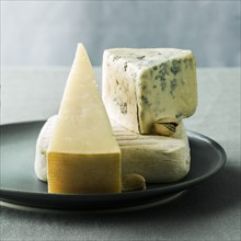 Wedges of cheese on plate