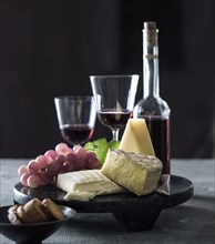 Cheese and grapes with red wine
