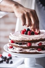 Chocolate cake with berries and cream filling