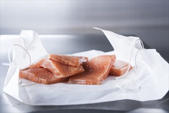 Raw salmon fillets on butcher paper