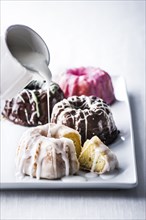 Icing pouring on miniature bundt cake