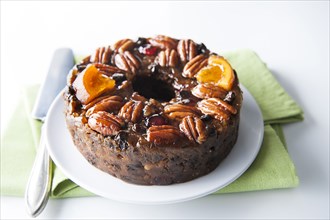 Fruit cake with pecans on plate