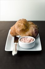 Popover with strawberry butter on plate