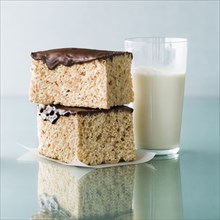 Stack of rice cakes with chocolate icing and milk