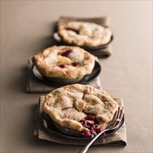 Miniature cherry pies with fork