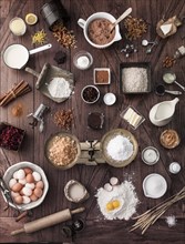 Scale and baking ingredients on wooden table