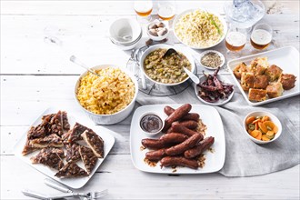Plates of food and beer on wooden table