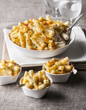 Bowl and cups of macaroni and cheese