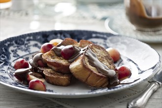 French toast with syrup and cherries