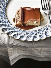 Flan on plate with syrup and fork
