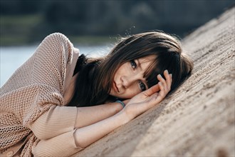 Caucasian woman laying on sand