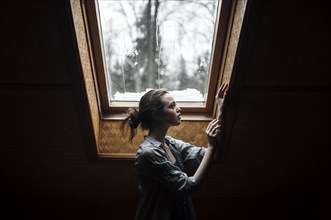 Caucasian woman standing under skylight