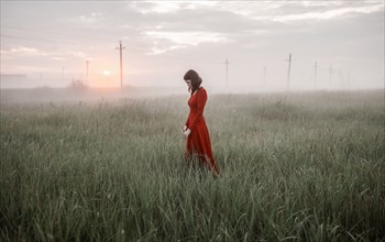 Caucasian woman walking in remote field